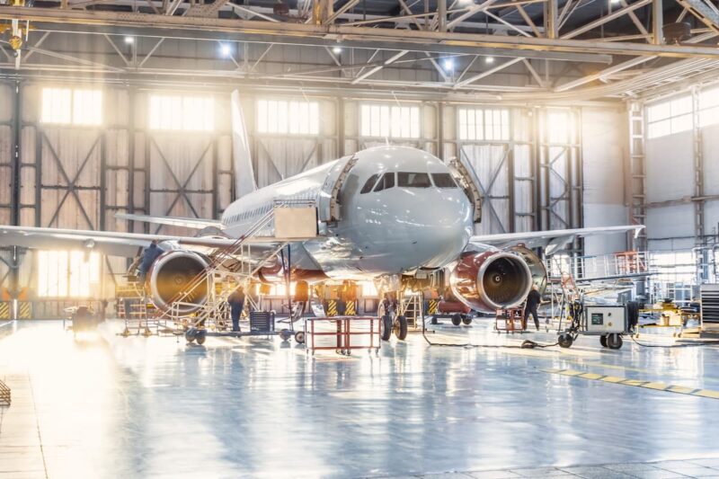 View inside the aviation hangar, the airplane mechanic working around the service.